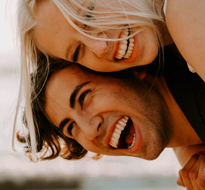 young man and woman smiling